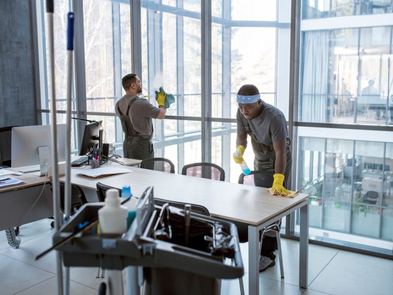 full-shot-men-cleaning-office_23-2149345516