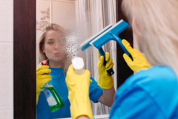 happy-young-woman-cleaning-with-spray-using-squeegee-wash-mirror-bathroom-cute-blonde-girl-wearing-yellow-protective-glove-working-home-housework-housekeeping-concept_132075-13115